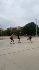 Pickup basketball on an outdoor court in Tarragona