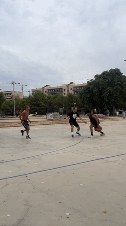 Pickup basketball on an outdoor court in Tarragona