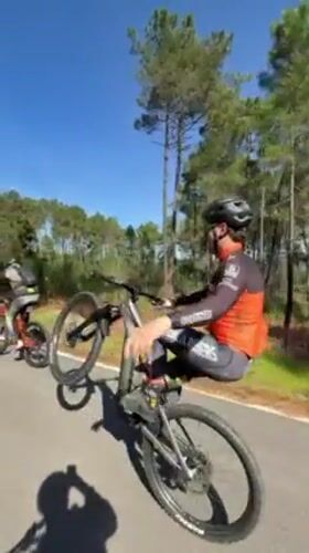 Cyclists perform wheelie stunts on Vila Real road