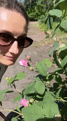 Woman enjoys spring roses in Kryvyi Rih garden