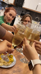 Group celebrates with champagne toast in Kuşadası kitchen