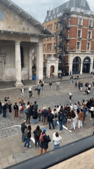 Street dancers perform for crowd in London square