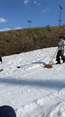 People gather on artificial snow hill in sunny Krasnoyarsk