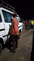 Street vendors and evening traffic at an outdoor urban market