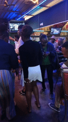Evening social gathering at Nairobi bar with neon lighting