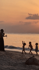 Families enjoy morning beach activities in Ko Pha-ngan, Thailand