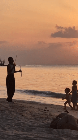 Families enjoy morning beach activities in Ko Pha-ngan, Thailand