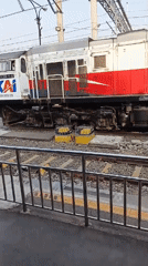 KAI commuter train stopped at Bogor station platform