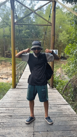 Tourist films phone footage while crossing suspension bridge in Vietnam