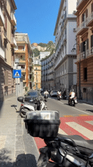 Narrow cobblestone streets and pastel facades in central Naples