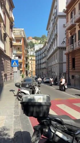 Narrow cobblestone streets and pastel facades in central Naples