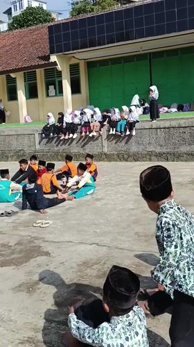 School children gather in groups during day at Indonesian school