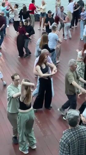 Salsa dancing on a wet riverside deck, Moscow River