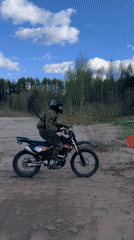 Dirt biker rides sandy beaches, forest trails in Chaikovsky
