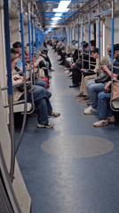 Commuters use phones during morning subway ride