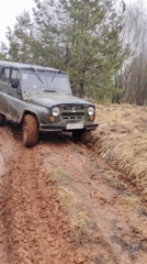 UAZ off-road vehicle navigates muddy forest track in Russia