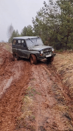 UAZ off-road vehicle navigates muddy forest track in Russia