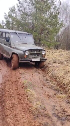 UAZ off-road vehicle navigates muddy forest track in Russia