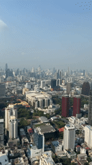 Aerial footage captures Bangkok cityscape under hazy sunny skies