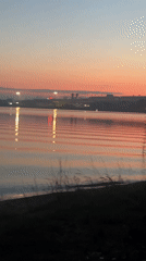 Quiet sunset reflects over calm water in Yekaterinburg