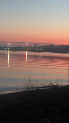 Quiet sunset reflects over calm water in Yekaterinburg