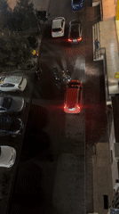 Nighttime street scene captured in Tbilisi with parked cars