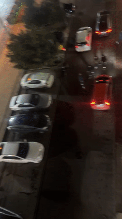 Nighttime street scene captured in Tbilisi with parked cars