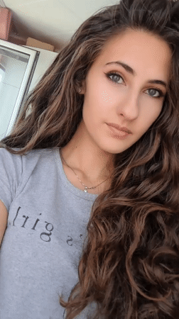 Woman takes selfies in Chepintsi, Bulgaria bedroom setting