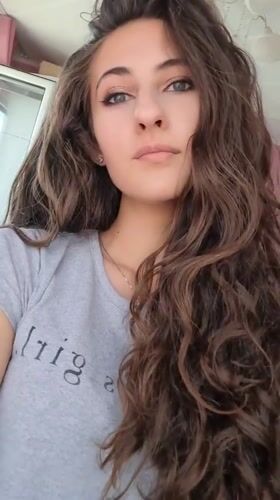Woman takes selfies in Chepintsi, Bulgaria bedroom setting