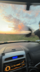Man cleans car windshield in Lehchevo, Bulgaria