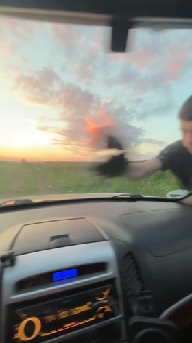Man cleans car windshield in Lehchevo, Bulgaria