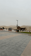 Tourists explore Dunhuang desert dunes from visitor plaza