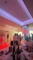 Wedding celebration with dancing and floral arrangements in banquet hall