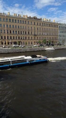 Passenger boat cruising a busy Saint Petersburg river