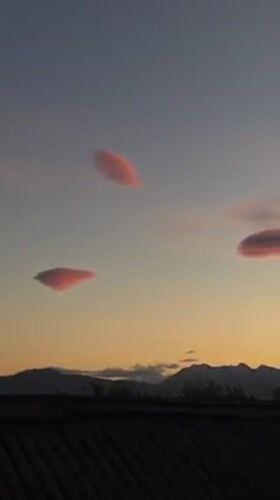 Pink lenticular clouds illuminate sunset sky over Ushuaia