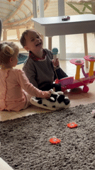 Children play with toy instruments in Kiryat Bialik home