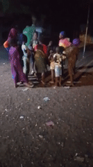 Children gather outdoors at night in Tamale, Ghana