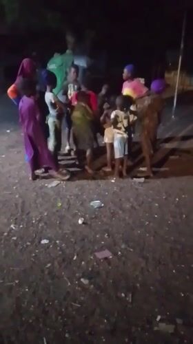 Children gather outdoors at night in Tamale, Ghana