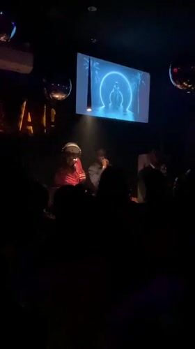 DJ performance captured at Abuja venue with animated backdrop