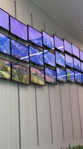 Wave-pattern TV wall displays nature scenes across dozens of screens