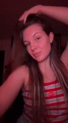 Woman enjoys wine, music in red-lit Belgrade apartment