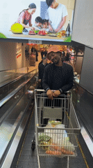 Shopper navigates supermarket escalator with full cart in Beijing