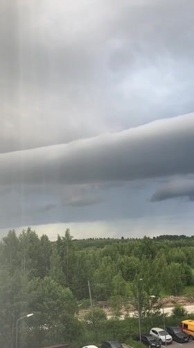 Evening storm clouds over Vsevolozhsk with toy robot scenes