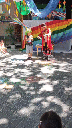 Clown performs for kids in Shymkent courtyard, rabbit in tow