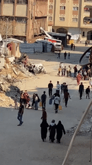 Residents navigate debris-lined streets in Khan Yunis
