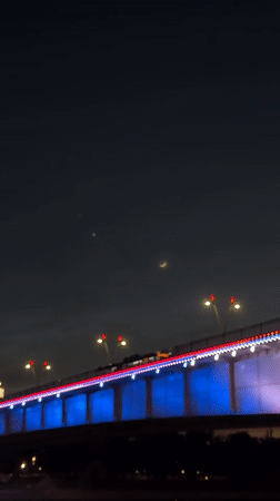 Belgrade's illuminated bridges and waterfront captured during evening twilight