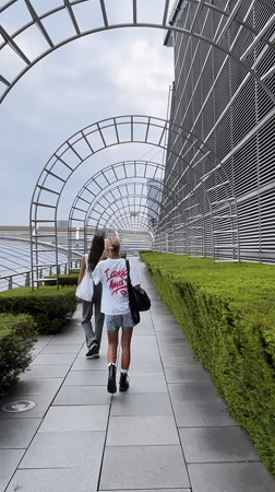 Walking through a sculptural archway corridor in Singapore