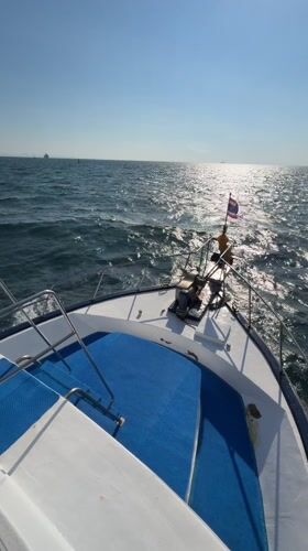 Man pilots motorboat in Thai waters near Wichit
