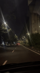 Driver travels illuminated street at night in South Jakarta
