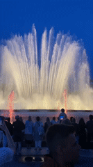 Crowd watches illuminated fountain show at Barcelona's Montjuïc